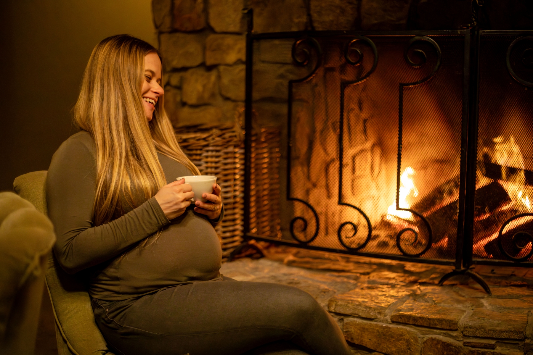 luxury-safaris-with-rhino-africa-at-kwandwe_D6A9689 Katharina lounges by a cosy fireplace, cradling a warm cup of tea and laughing during her babymoon safari.